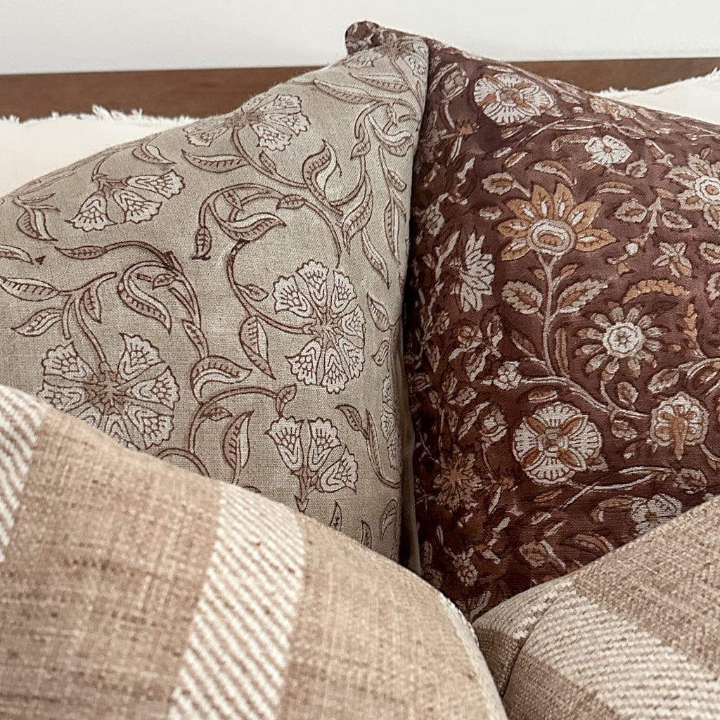 Closeup view of Agnes and Mae block printed pillows, showing their floral detailing.