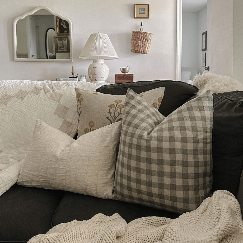 A close up of three pillows in the corner of a couch. Remington, Maxwell, and the Logan Lumbar