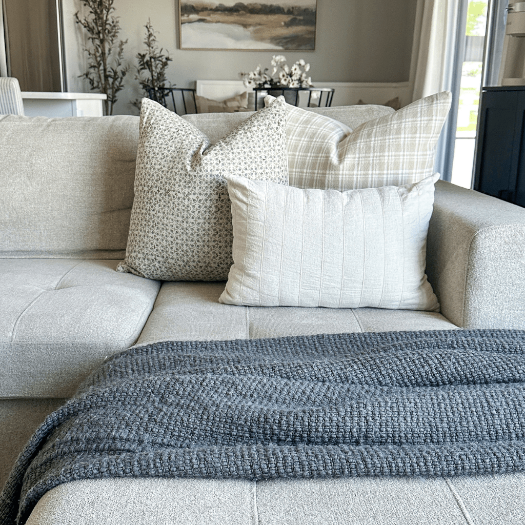  Beatrice, Copeland, and Logan Lumbar on a grey sofa