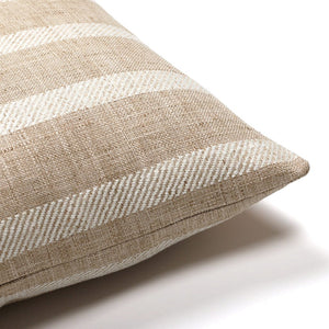 Upper corner of Caspian lumbar pillow cover showing flax and taupe stripped pattern on the front and back of the pillow. Set on a white background.