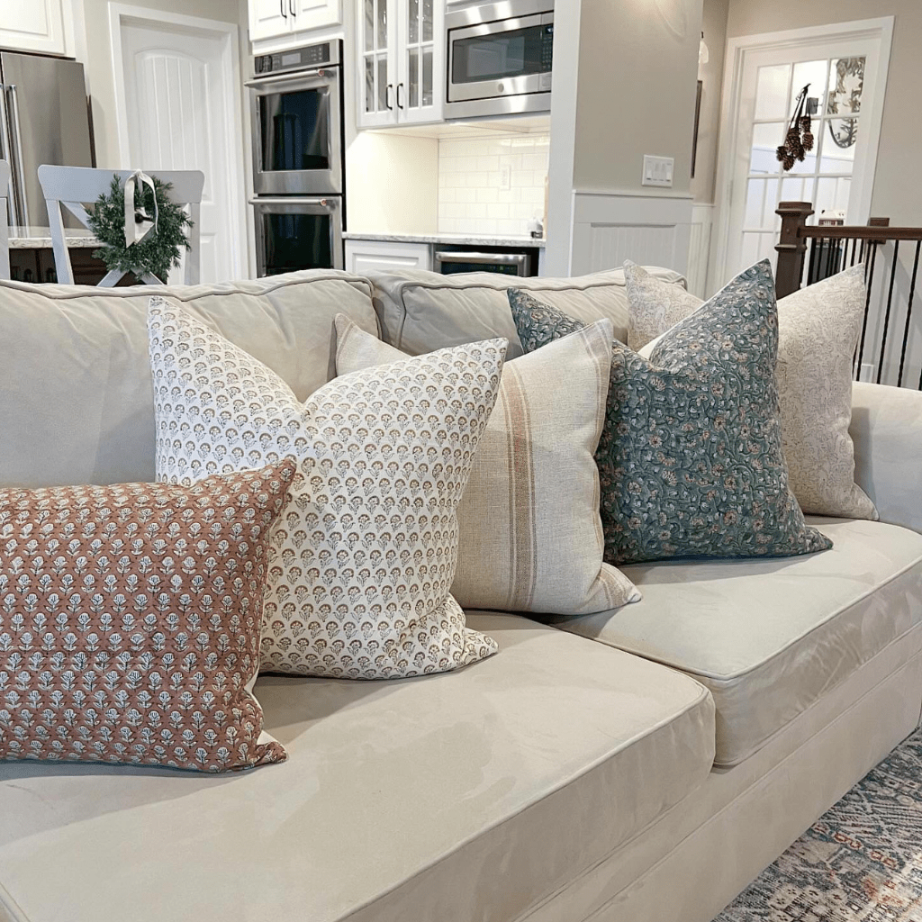 Delilah, Lydia, Arizona, Luella, and EmeryLumbar sitting on a beige couch in a living room