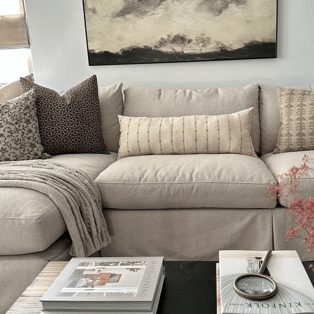 Closeup of a beige couch with Forrest, Neville Mocha, and Rory Lumbar