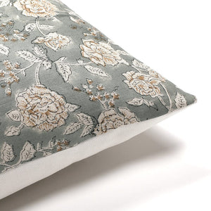 Upper corner of the Lenora pillow cover from Colin and Finn showing the floral front and solid ivory backing.