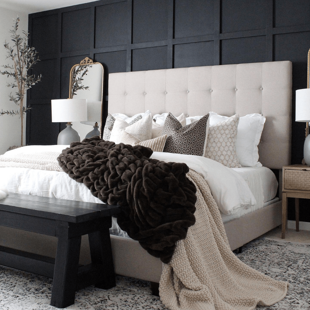 A cream bed against a black wall with a dark brown blanket and Madison, Neville Mocha, Livvy, Karina, Jade, Logan, and Bardot Lumbar pillows