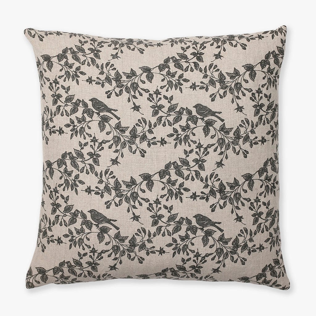 Magnolia pillow cover from Colin and Finn showing a taupe textile with charcoal bird and floral motif.