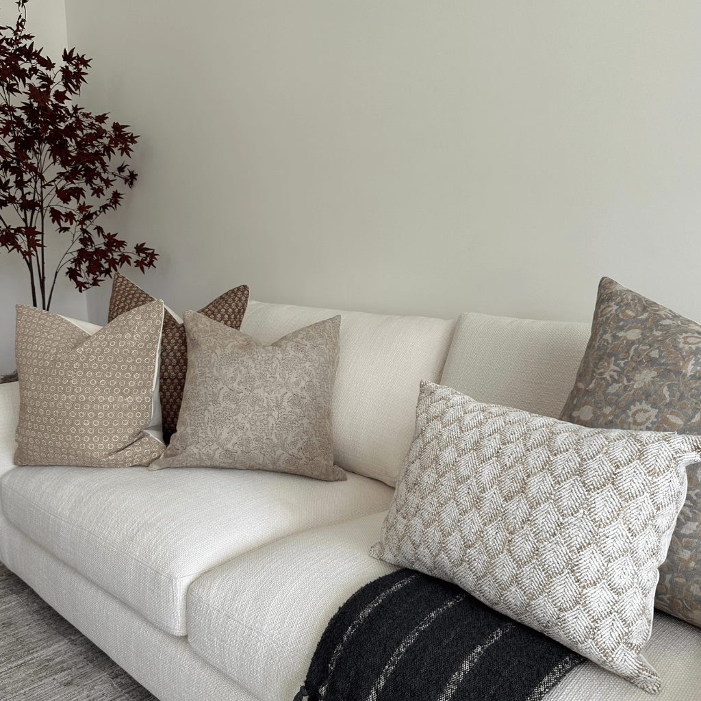 A cream sofa with Matilda, Kennedy, Louise, Emery, and Jade Lumbar throw pillows from Colin + Finn