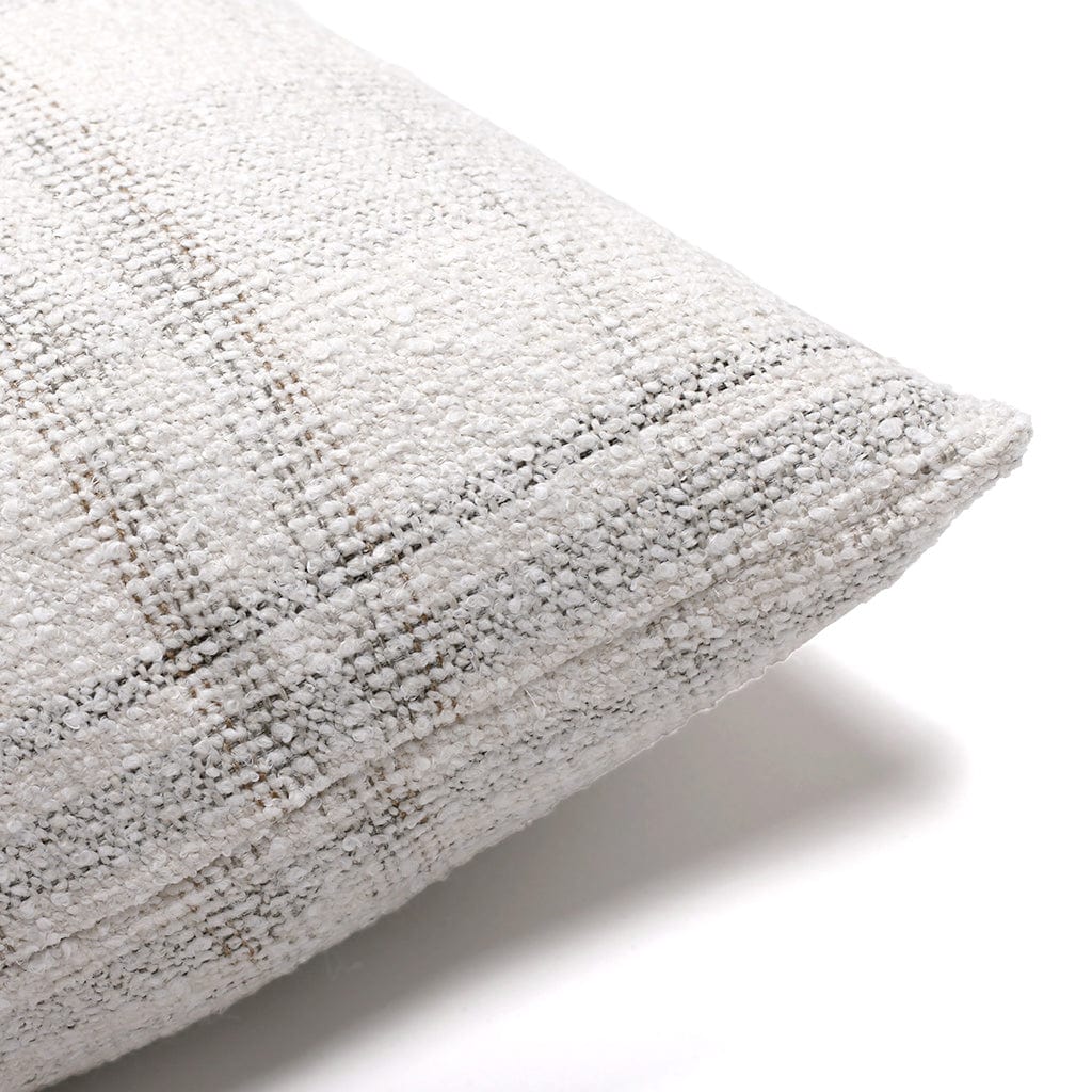 Close-up of a corner of a beige pillow with a textured fabric and a subtle checkered pattern. The pillow appears to be made of a woven material, and the image is taken against a plain white background.