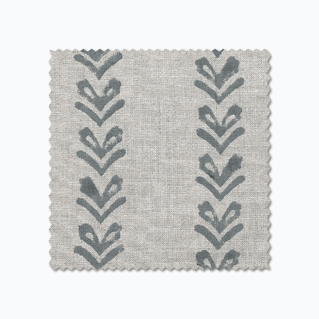 Blaine fabric swatch from Colin and Finn. Blue arrows on a gray fabric