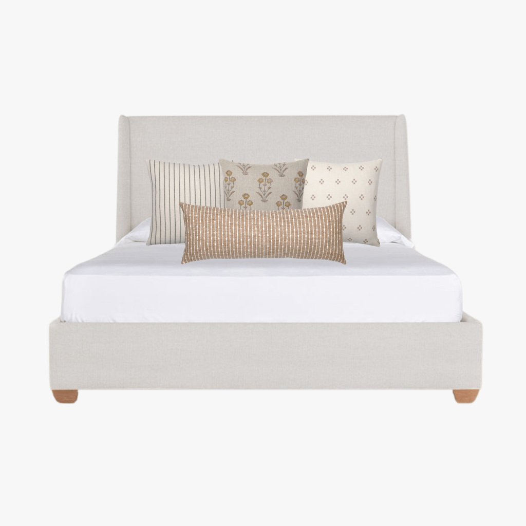 Mockup of Savanna pillow combo from Colin and Finn on cream bed.